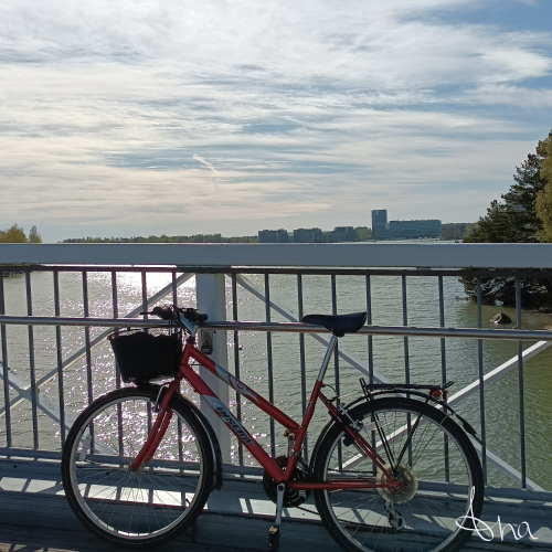 Red bike on a bridge between islands in Southern Finland